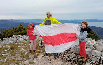 How a Father and His Children Travel Through the Mountains With a White-Red-White Flag